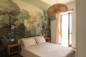a bedroom with a large painting on the wall at Sky & Vineyards - Melograno - in La Morra +18 photos