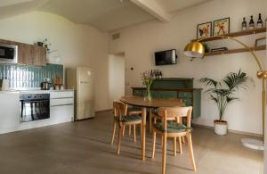 a kitchen with a table and chairs in a room at Sky & Vineyards - Melograno - in La Morra
