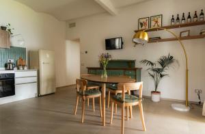 a kitchen and dining room with a table and chairs at Sky & Vineyards - Melograno - in La Morra