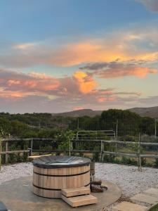 a wooden barrel with a cover on top of it at River House at Rivierplaas in Stilbaai