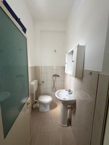 a bathroom with a toilet and a sink at Hotel Parking Pika in Shëngjin +18 photos