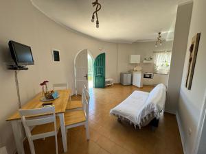 a kitchen and dining room with a table and chairs at Razos Windmill in Vathi