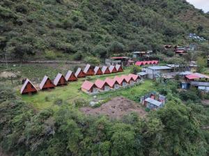 an aerial view of a group of tents on a hill at Pablito Hostel Challhuay in Colcapampa