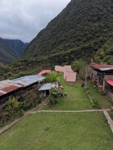 a group of buildings with a mountain in the background at Pablito Hostel Challhuay in Colcapampa +8 photos