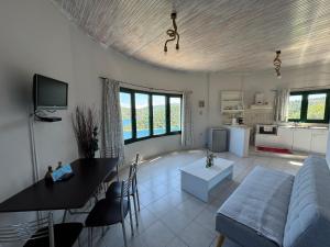 a living room with a couch and a table at Razos Windmill in Vathi
