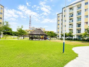 a gazebo in a park in front of a building at Residential Capital Plus in Accra