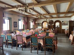 a dining room with tables and chairs in a room at Albergo Genziana in Bormio +36 photos