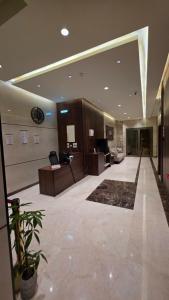 a lobby of a building with a desk and a couch at سجى الهدوء للشقق المخدومة in Abha