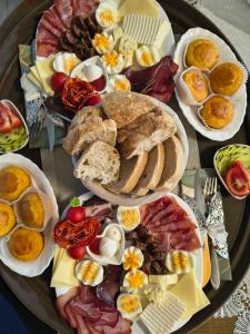 a tray of different types of food on a table at Vila Danida in Žabljak