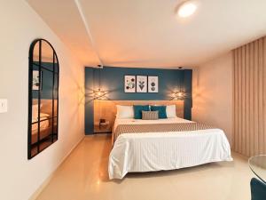 a bedroom with a large bed and a mirror at Hotel Quinta de Cabecera in Bucaramanga