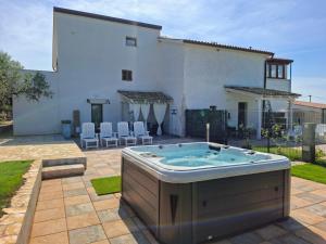 a hot tub in the backyard of a house at Apartments Casa Sossa in Vilanija