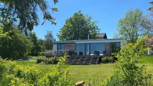 a modern house with glass doors on a lawn at Cottage2Rest in Erbach