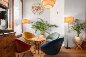 a room with chairs and a table with plants at Hotel Bernerhof in Interlaken