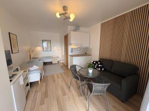a living room with a couch and a table at Endla Hostel ja Apartamendid in Haapsalu