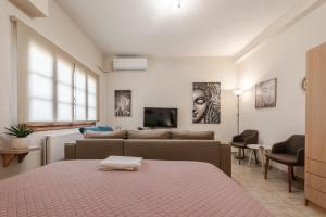 a living room with a bed and a couch at ZoYa`s Apartments in Agria