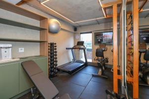 a room with a gym with a treadmill and weights at Motto By Hilton Recife in Recife
