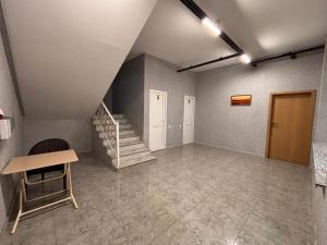 a room with a staircase and a table and a stair case at Park Hotel in Quba