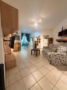 a living room with a couch and a table at Casa Vacanze Cau de Mezo in Marina Julia