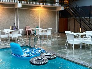 a pool with some tires in the water at Hotel Asiia Holiday with Swimming Pool -Central Heated and Air Cooled, Near mall road in Kasol +81 photos