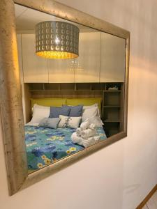 a mirror reflecting a bed in a room at Casa Vacanze Cau de Mezo in Marina Julia +35 photos