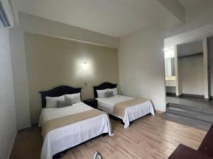 a hotel room with two beds in a room at Hotel Plaza del Arco - Monterrey in Monterrey +31 photos