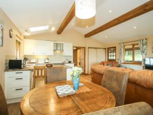 a kitchen and dining room with a wooden table at Valley View Lodge in Trelystan
