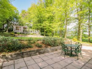 a patio with a table and chairs in a park at Valley View Lodge in Trelystan