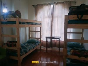 a bedroom with two bunk beds and a table at Serene Lodge in Shillong