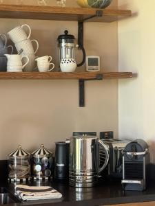 a kitchen counter with appliances on a counter top at Hobbs Hole Cottage & Studio in Great Tew