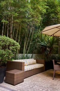 a patio with a couch and an umbrella at Royal Collection Paulista in São Paulo