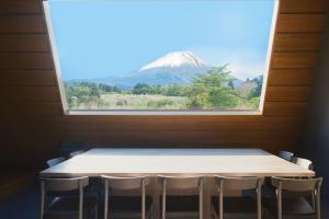 a table with a view of a mountain through a window at THE THIRD PLACE Mt Fuji in Fujikawaguchiko +43 photos
