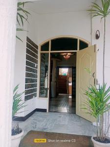 an entrance to a house with a door and plants at Serene Lodge in Shillong