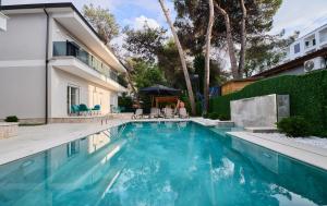 a swimming pool with blue water in a yard at Blue Golem Durres Albania in Golem