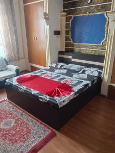 a bed with a red shirt on it in a room at Serene Lodge in Shillong