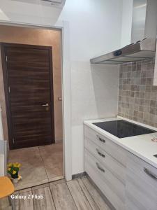 a kitchen with a sink and a door in it at Fortuna in Diano Marina