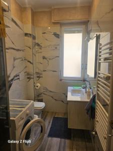 a bathroom with a sink and a toilet and a window at Fortuna in Diano Marina +3 photos