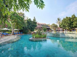 a swimming pool at a resort with blue water at Novotel Bali Nusa Dua in Nusa Dua