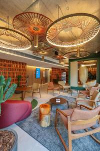 a lobby with chairs and tables in a building at Motto By Hilton Recife in Recife