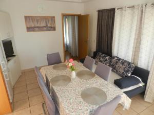 a dining room table with chairs and a couch at Apartments Lea in Orebić