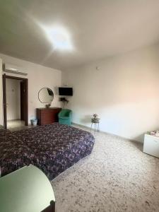a bedroom with a bed and a table in it at Lincoln B&B in Caserta