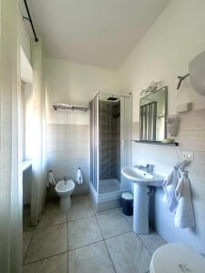 a bathroom with a sink and a shower and a toilet at Lincoln B&B in Caserta