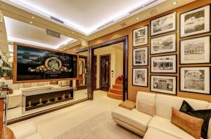 a living room with a large tv and a couch at MariaHilferHome in Vienna