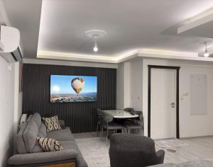 a living room with a couch and a balloon on the wall at Saklıkonak Otel in Isparta