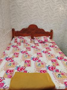 a bed with pink and pink roses on it at JSM DELUXE Ac in Vellore