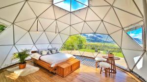 a bedroom with a bed in a room with a large window at Amatea de Villa de Leyva in Villa de Leyva +34 photos