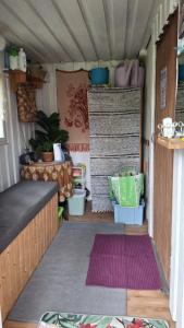 an inside view of a tiny house with a rug at B&B RhinoSauna in Vihti
