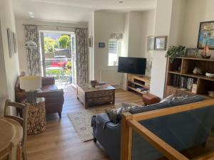 a living room with a couch and a tv at Hamnavoe in Dartmouth
