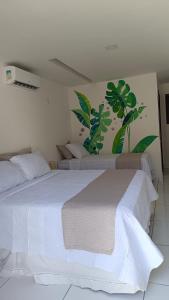 a bedroom with two beds with white sheets at Casa Blanca in Galinhos +46 photos