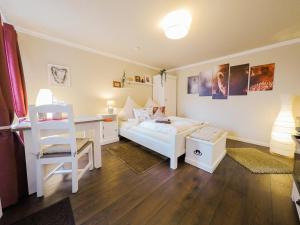 a bedroom with a desk and a white bed and a desk and a desk at Friendly Home Doppel-Doppelappartement Union in Bornheim