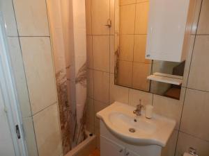 a small bathroom with a sink and a shower at Apartments Lea in Orebić +63 photos
